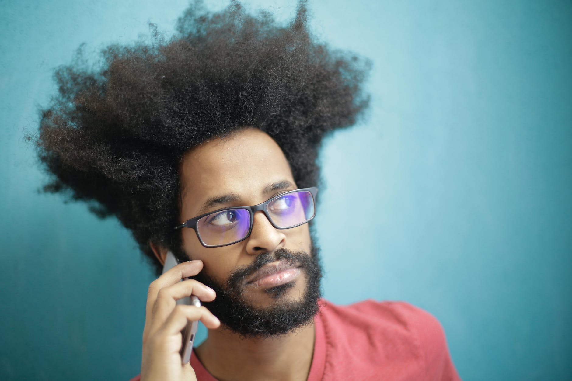 man in red crew neck shirt wearing black framed eyeglasses