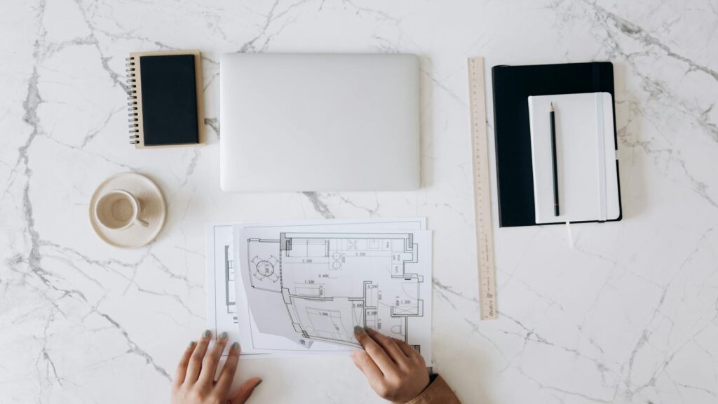 an architect s work table with tools and blueprints